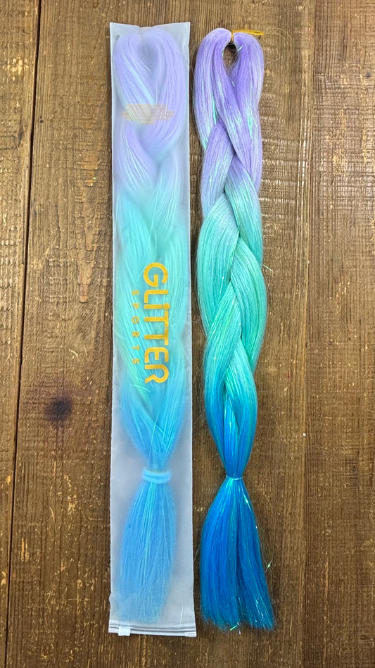 Ombre rainbow tinsel hair extension braids  with purple, mint and aqua blue colours on wood background.