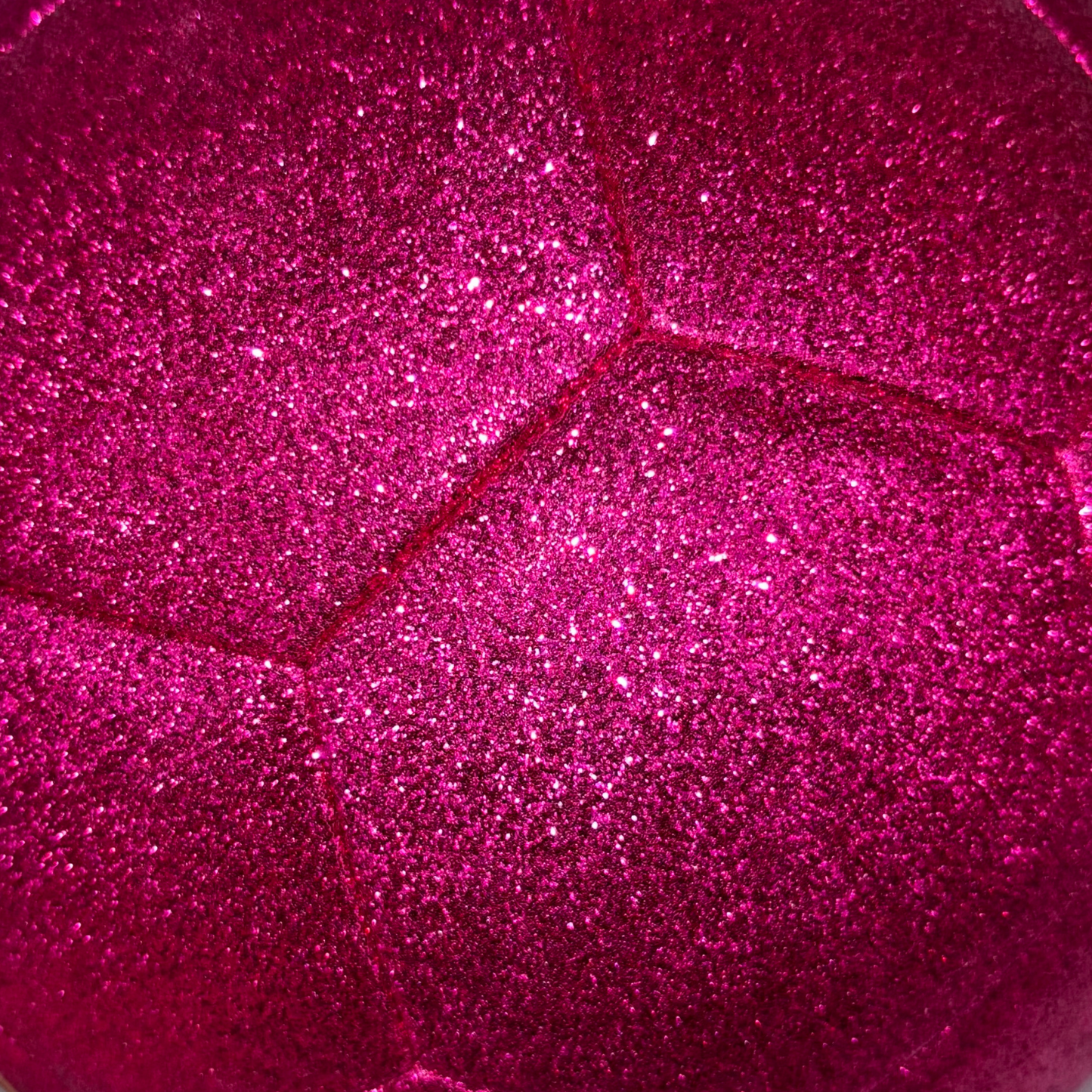 Close up of sparkly, bright pink glitter soccer ball exterior.