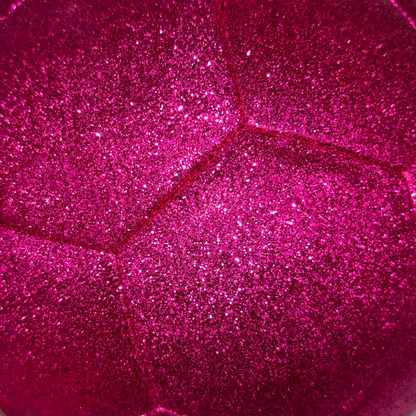 Close up of sparkly, bright pink glitter soccer ball exterior.