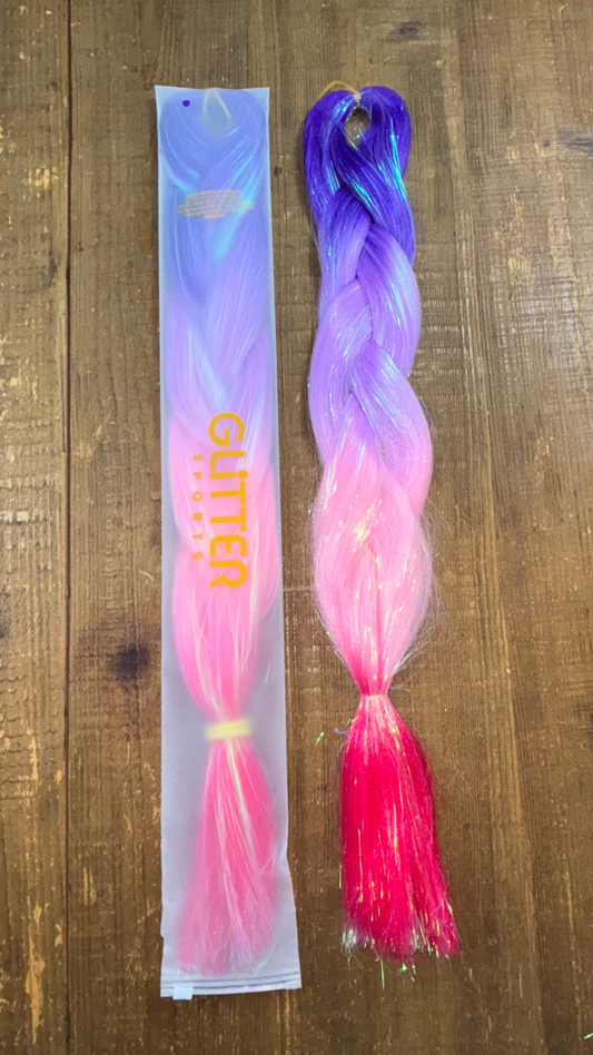 Ombre synthetic hair extension braids in purple, lavender, baby pink and bright pink with tinsel ribboning through on wood background.