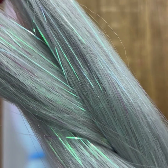 Close up of girls ombre tinsel braids in silver, lavender and blue.