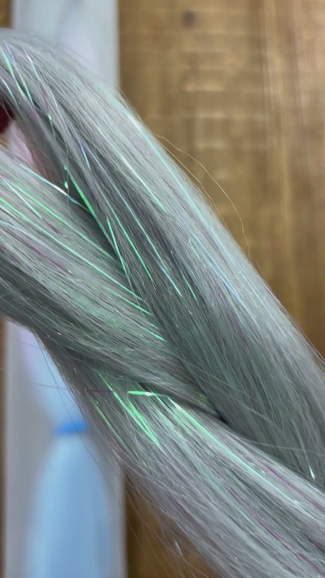 Close up of girls ombre tinsel braids in silver, lavender and blue.