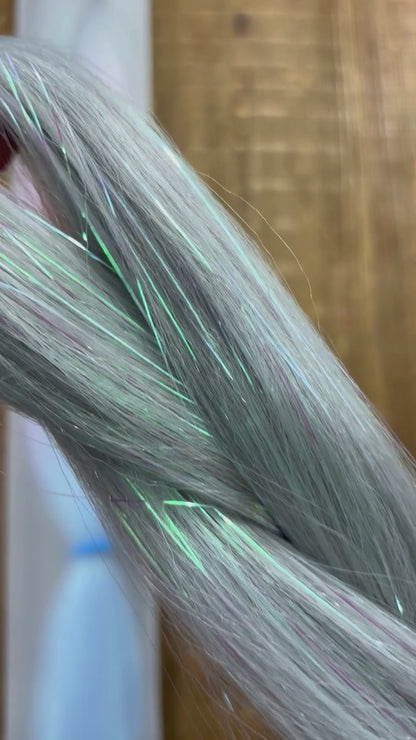 Close up of girls ombre tinsel braids in silver, lavender and blue.