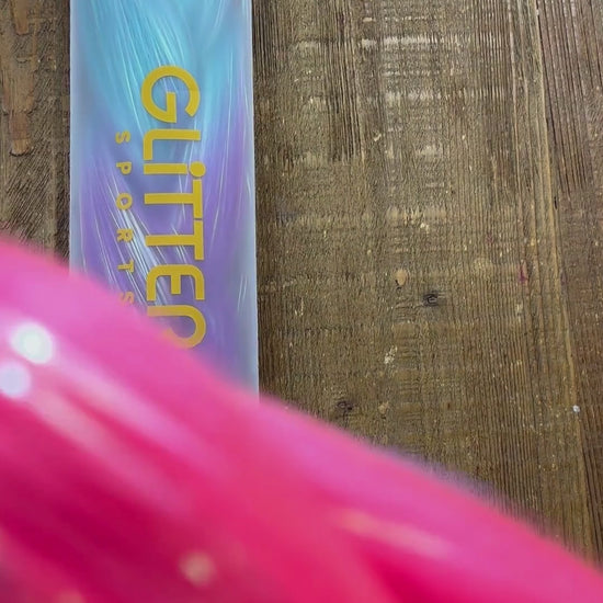 Video showing close up of rainbow tinsel colours in synthetic braids extensions. Colours include fuchsia, blue, magenta purple and golden yellow.