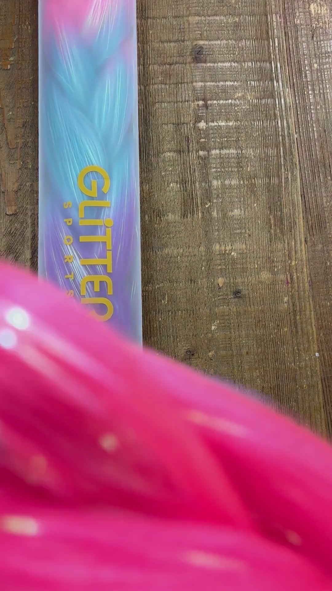 Video showing close up of rainbow tinsel colours in synthetic braids extensions. Colours include fuchsia, blue, magenta purple and golden yellow.